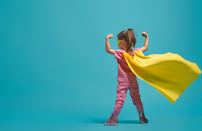 little girl with hero cape