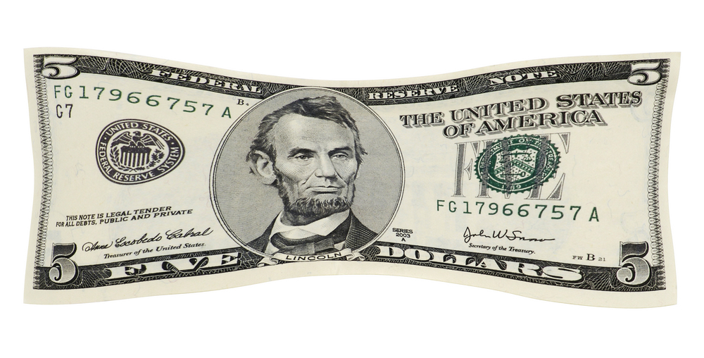 US five dollar bill being stretched